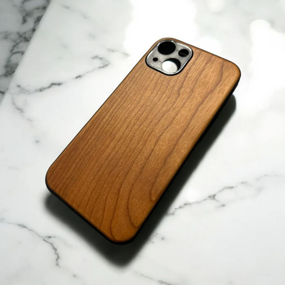 Wood grain phone case on white marble background.
