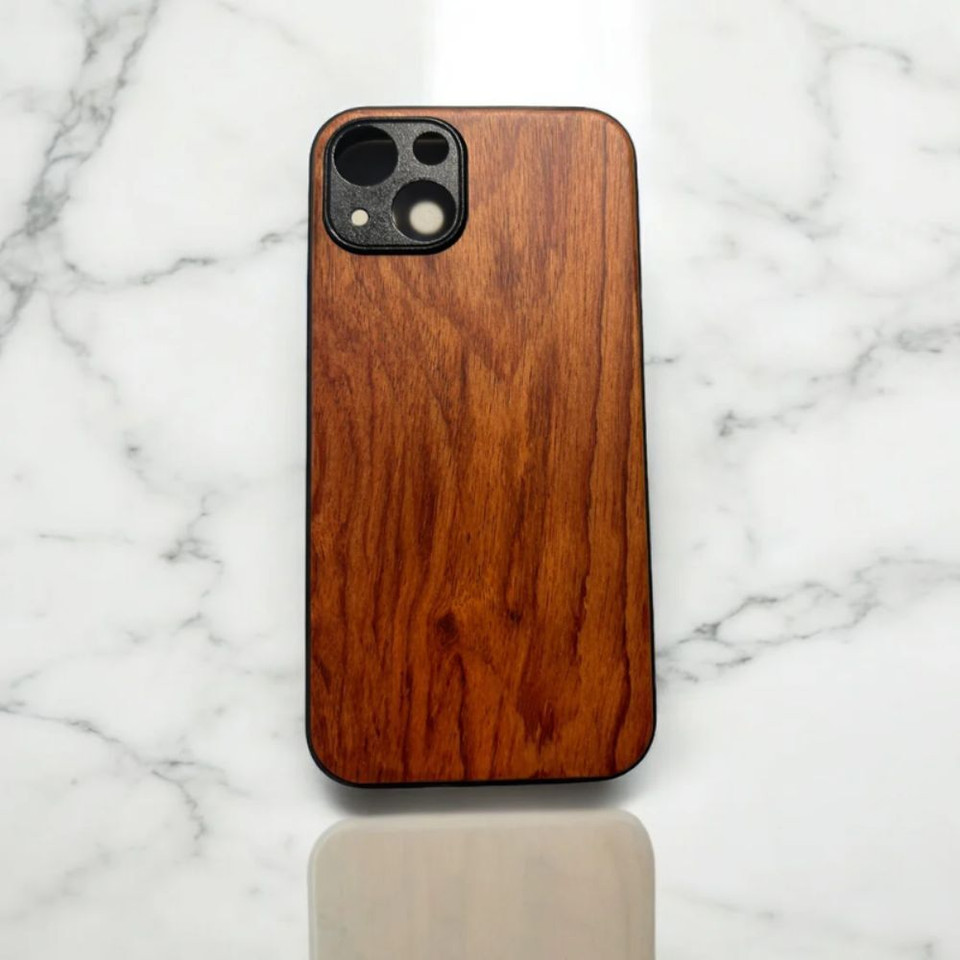 Wooden phone case with a natural finish on a marble surface.