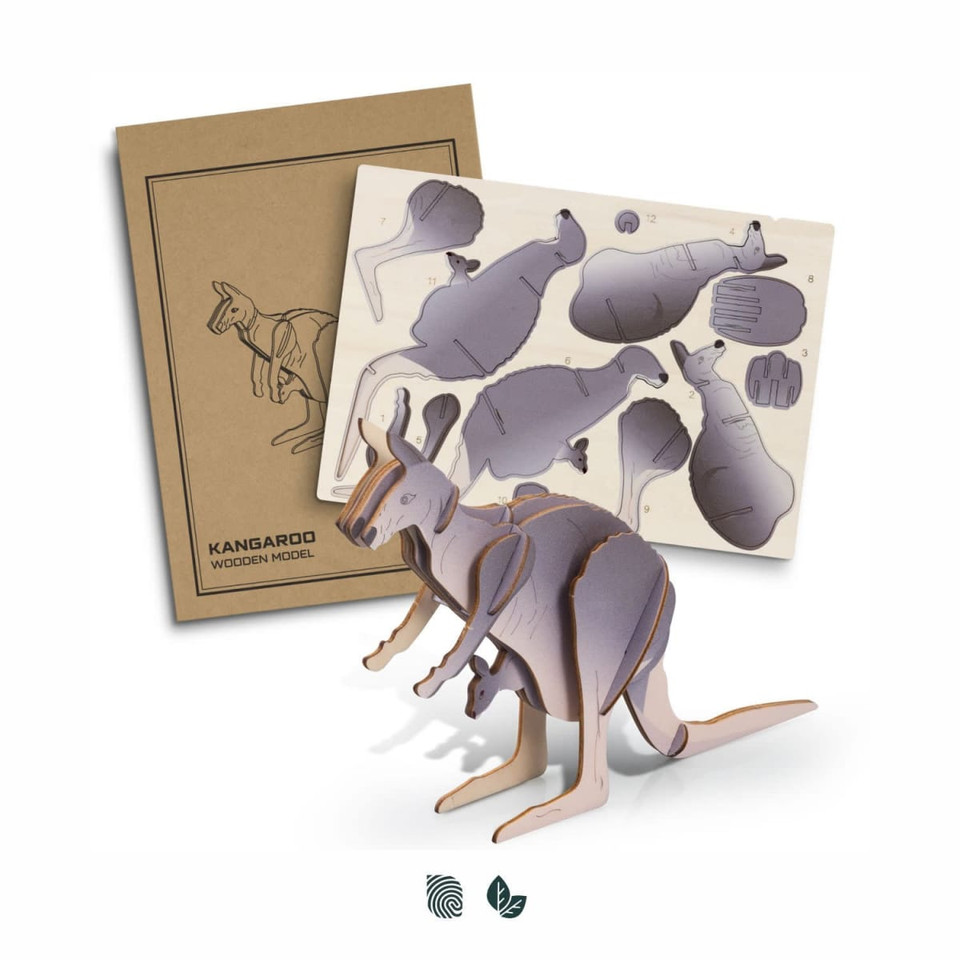 A wooden model of a kangaroo in natural wood tones, next to a craft sheet with assembly pieces and instructions.