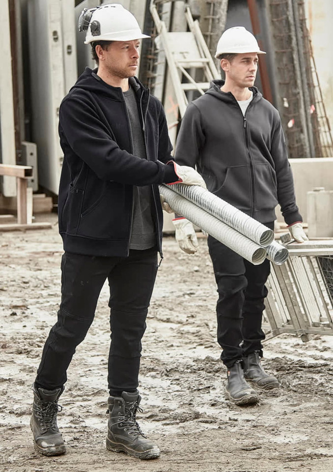 Unisex zip front multi-pocket hoodie in black, worn by two men on a construction site, carrying pipes. Both wear hard hats.
