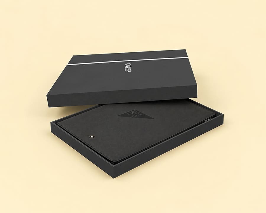A black leather notebook with debossed logo