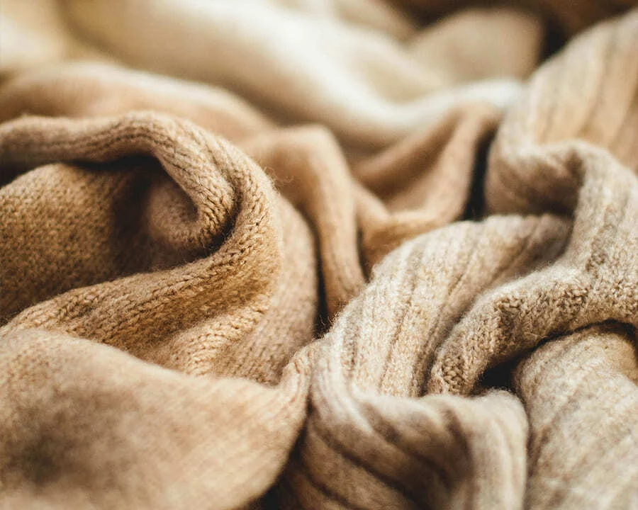 A close-up of two beige jumpers