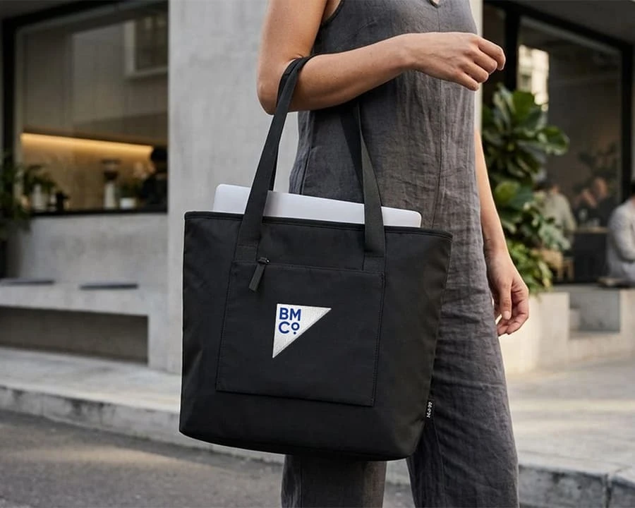 A woman carrying an American Tourister duffle bag