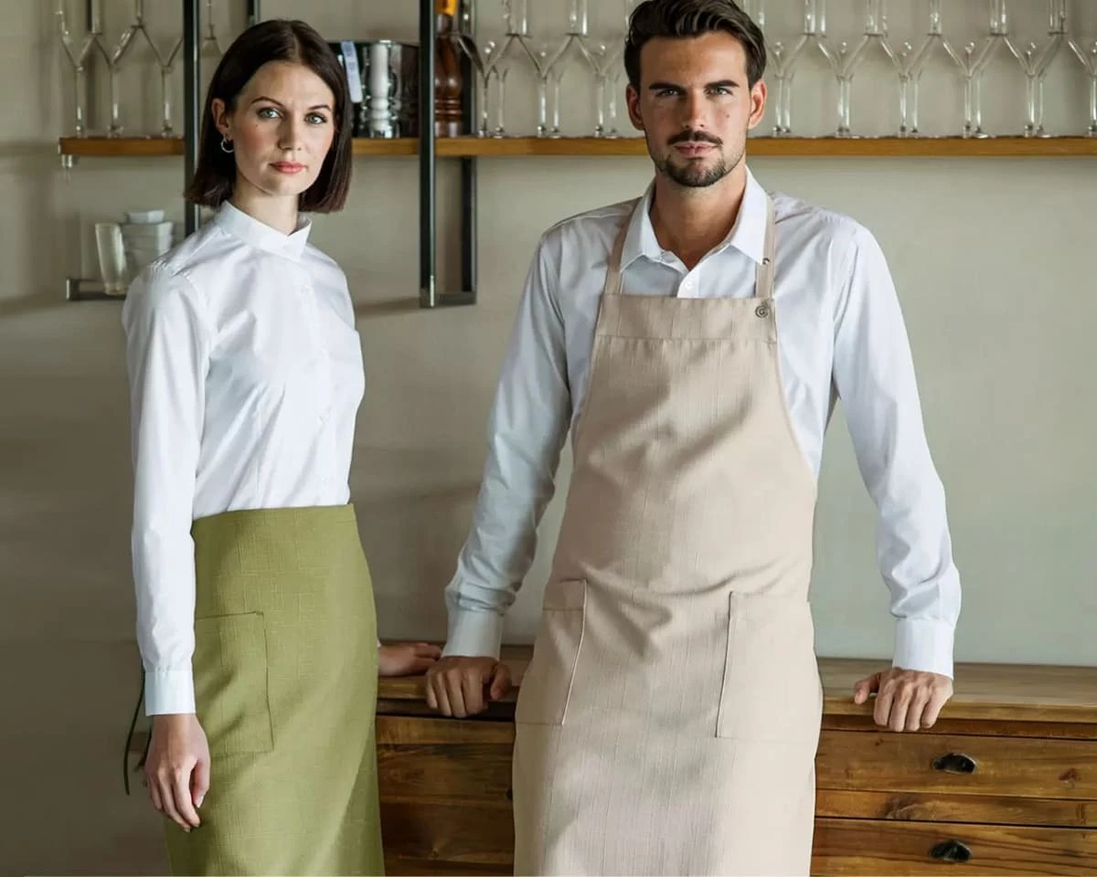 A man and a woman wearing giblor patmos aprons
