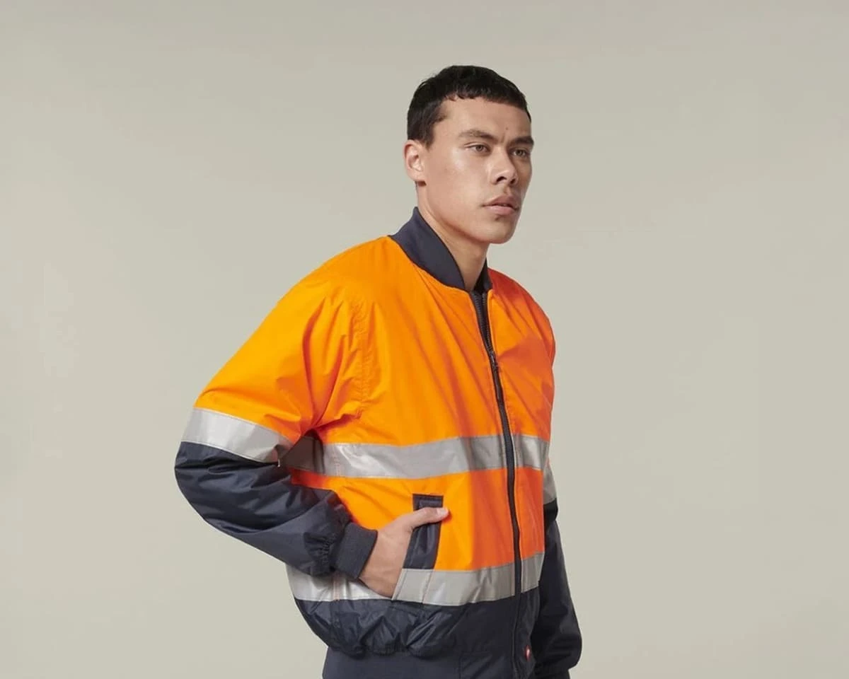 A man wearing a core hi-vis two tone Hard Yakka waterproof bomber jacket