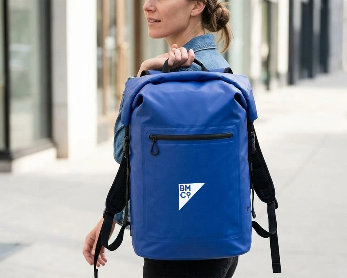 A woman carrying a blue 35ml cirrus Stormtech backpack