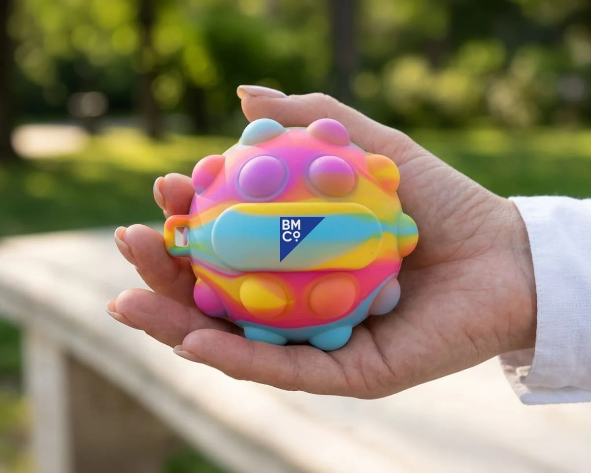 A woman holding a colourful stress popper ball
