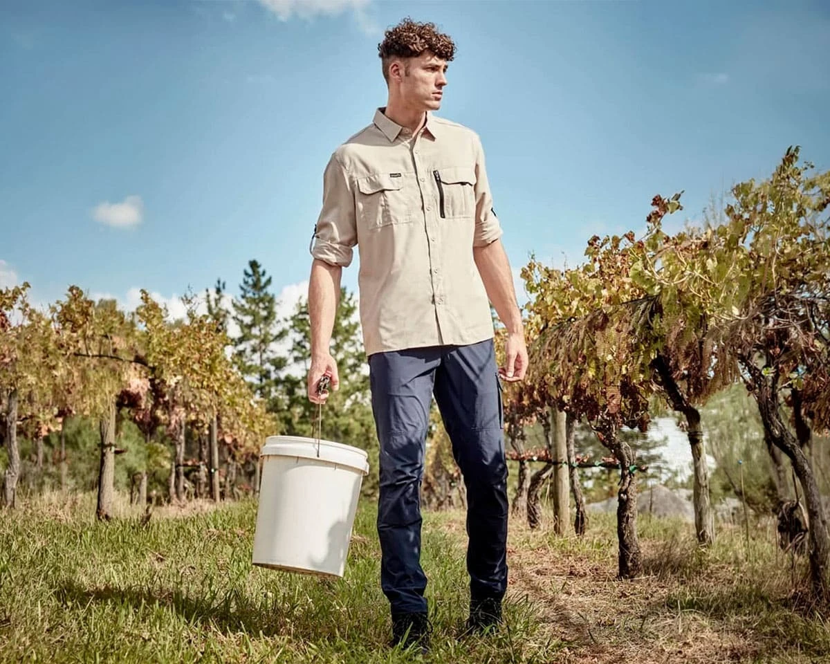 A man wearing an outdoors Syzmik long sleeve shirt