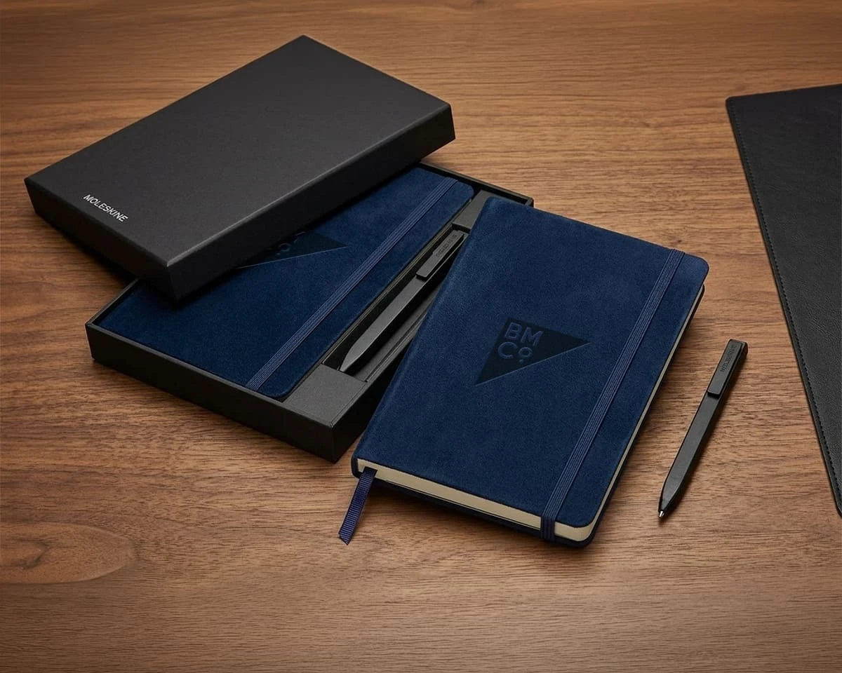 A navy blue Moleskine notebook and pen set