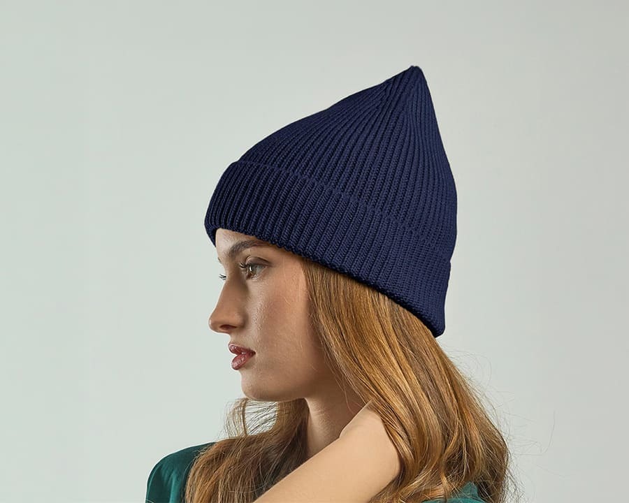 A woman wearing a dark blue recycled Atlantis andy beanie