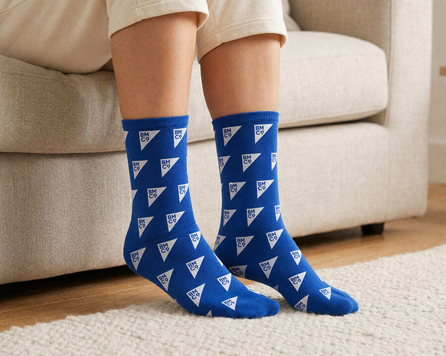 A woman wearing blue magic seamless socks with a Brilliant Merch Co pattern