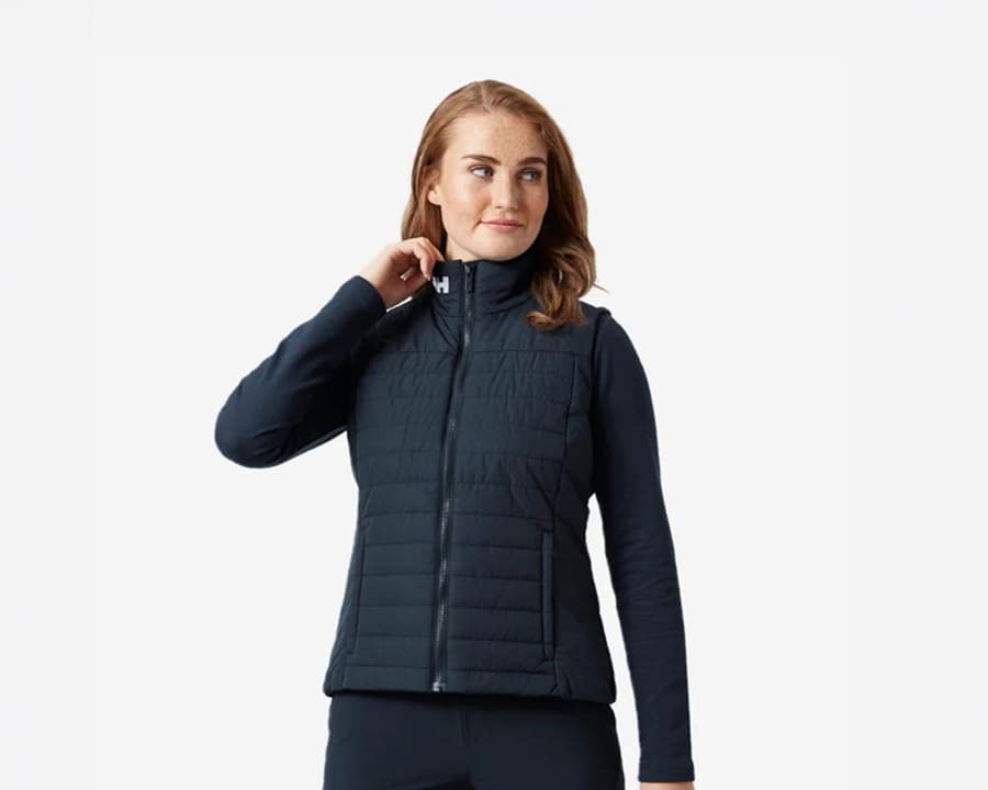 Woman adjusting the collar on her Helly Hansen crew insulator vest