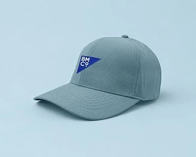 A petrol blue Legend Black sail cap with embroidered Brilliant Merch Co logo