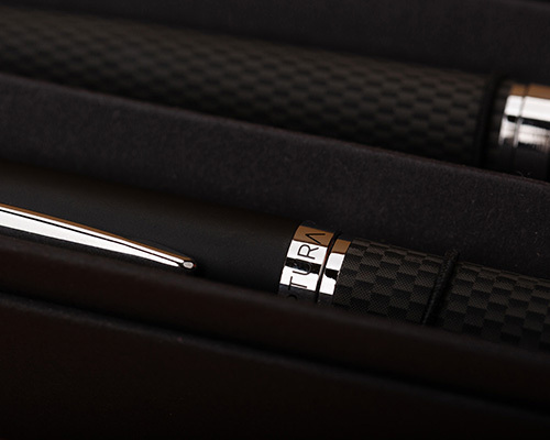 A close-up of a luxury pen set in a black box