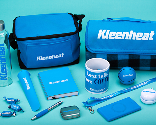 Various blue promotional items, including bags, a water bottle, mug, notebook, and more