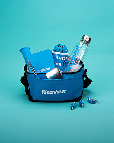 Blue kleenheat branded bag with branded items including a water bottle, notebook, pen, stress ball, mints, and candies