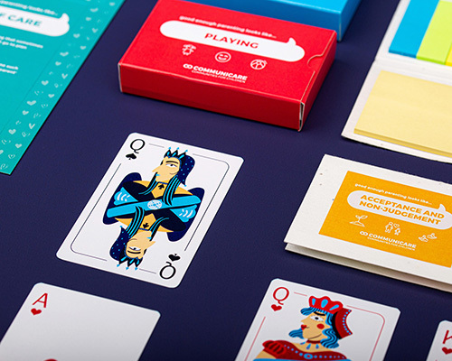 A collection of playing cards on a dark surface, featuring vibrant designs and packages