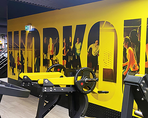 Bright gym interior with a bold yellow wall
