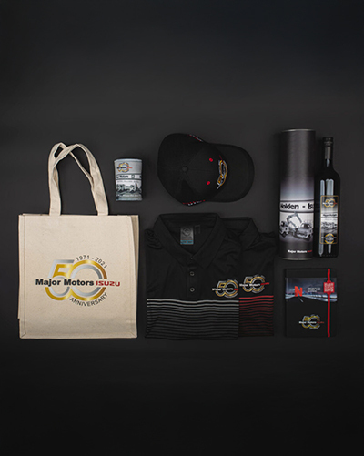 A collection of branded merchandise, a tote bag, shirts, a hat, a wine bottle, and more