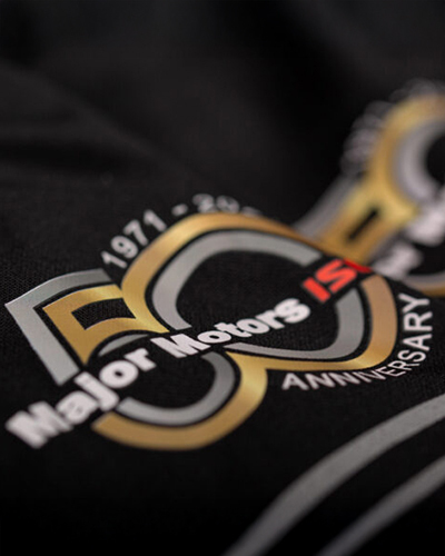 A close-up of a bBlack t-shirt featuring a bold 50th anniversary logo