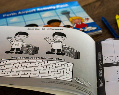 Children's activity book open to a page featuring a "spot the difference" puzzle and a maze