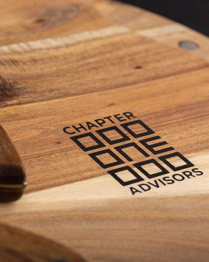 Close-up of chapter one advisors logo on cheese-board