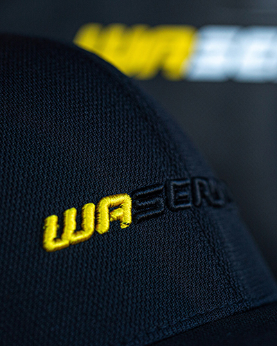 Close-up of a black hat with wa seadoo embroidery