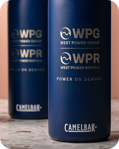 A close-up of blue camelbak supplied bottles branded with wpg west power group and wpr west power rentals
