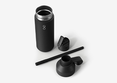 A sleek black stainless steel water bottle with a lid, a straw, and a cap, all arranged