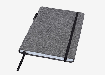 A grey linen-textured notebook with a black elastic band and bookmark