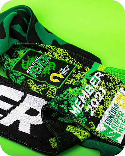 A close-up image of a west coast fever branded knitted scarf