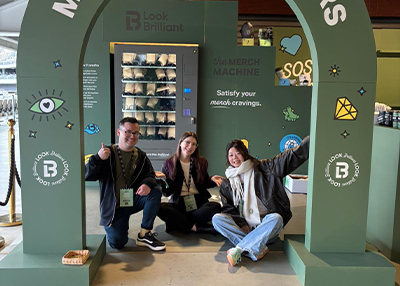 Happy look brilliant staff posing next to the vending machine