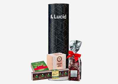 Gift set including a black cylindrical box, chocolates, a natural soap box