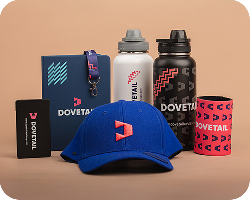 A collection of Dovetail-branded merchandise including a blue cap, black and white water bottles, a notebook, and more