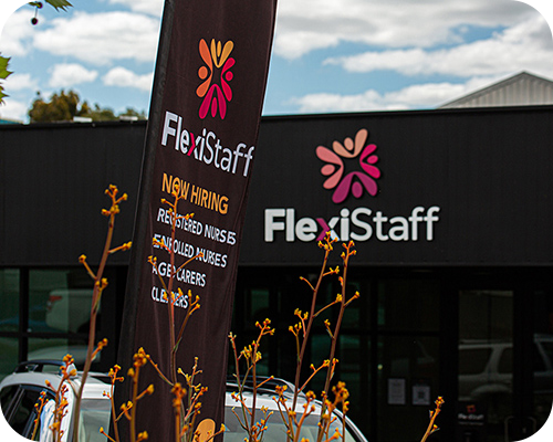 FlexiStaff building with a 'now hiring' sign