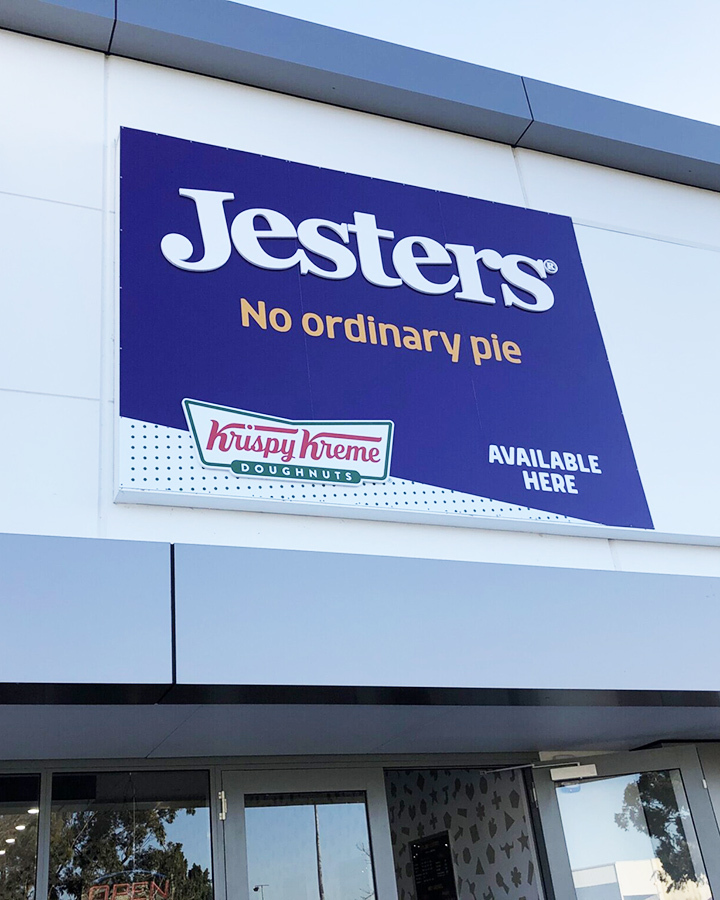 A large jesters sign above storefront