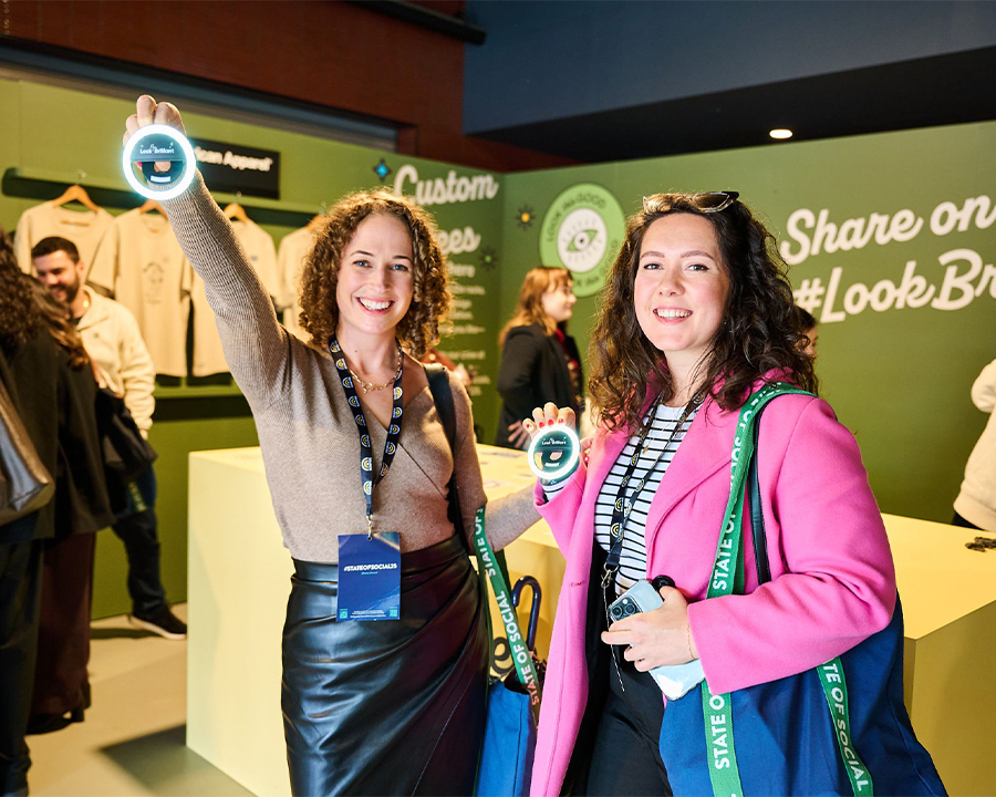 Two happy attendees at State of Social interacting with Look Brilliant activation
