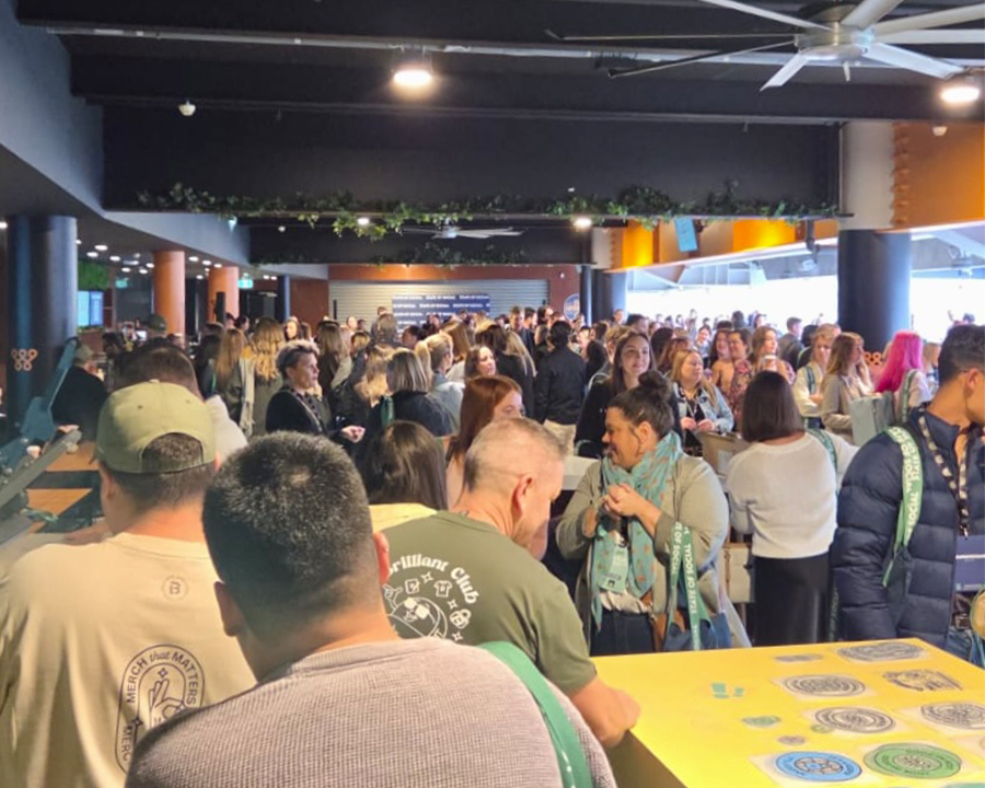 A crowd of attendees at State of Social walking towards Look Brilliant activation