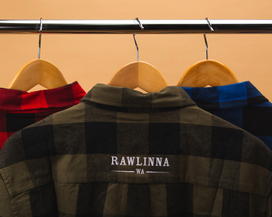 Three flannel shirts hanging on a rack