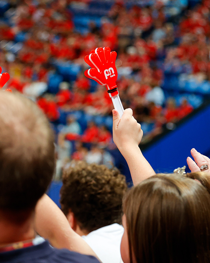 Person holding custom clapper at an event