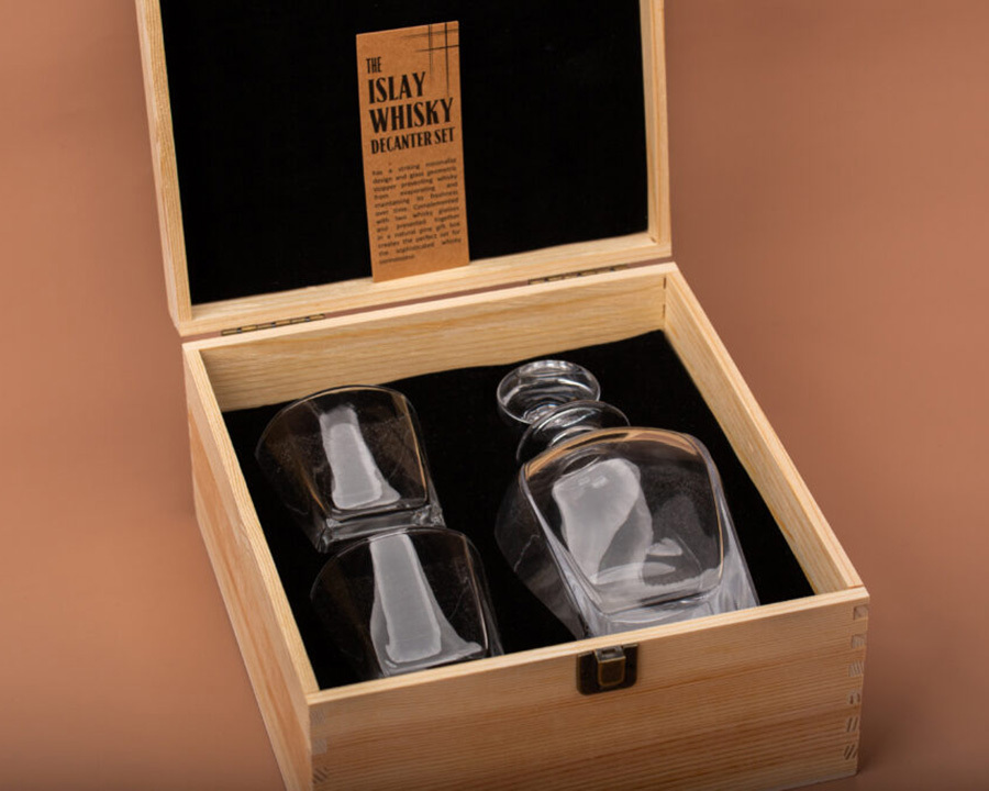 Whisky glasses and bottle in a wooden box