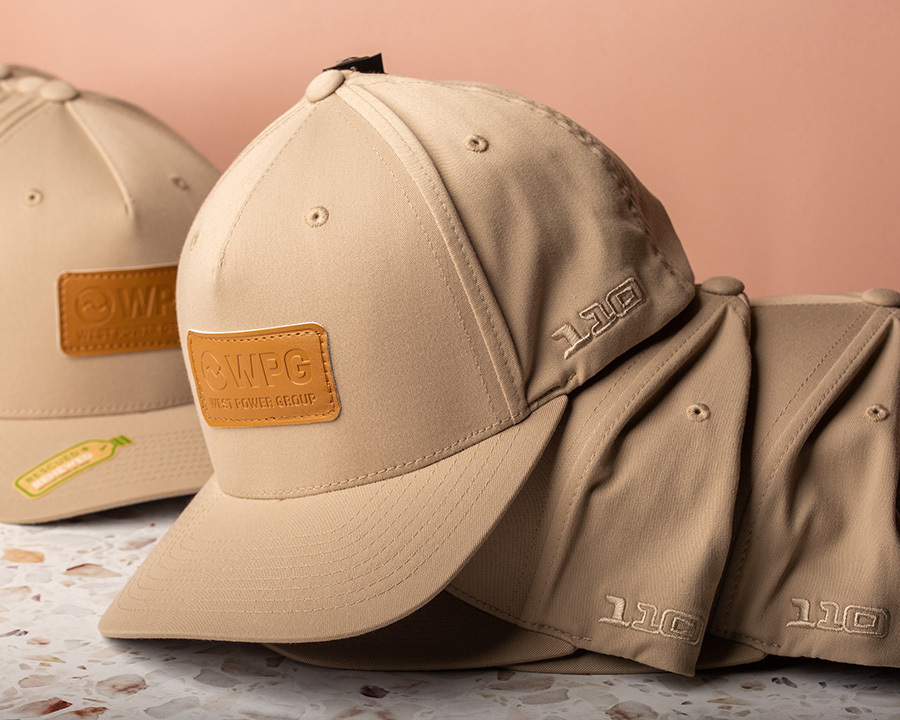 a collection of beige wpg hats