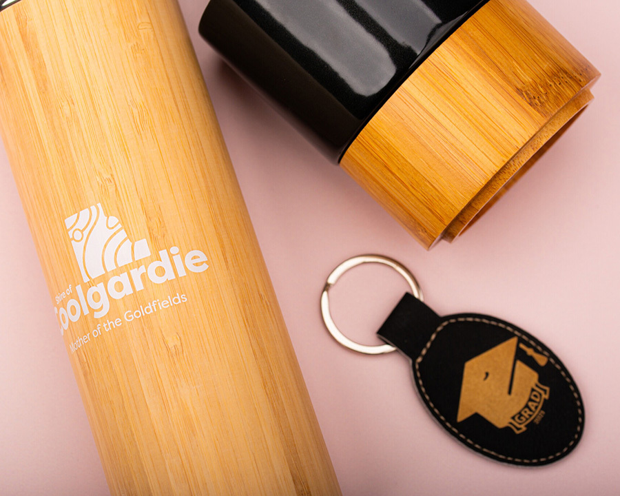 A close-up of a wooden coolgardie bottle and keychain