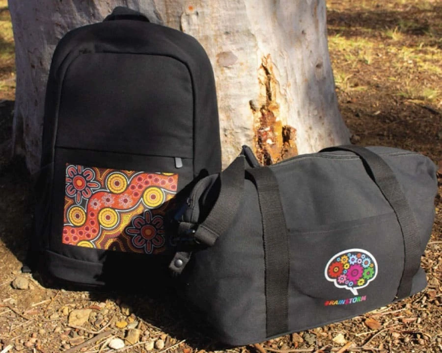A black backpack and duffel bag outdoors