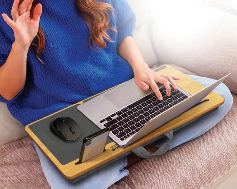 A woman using a laptop on a couch