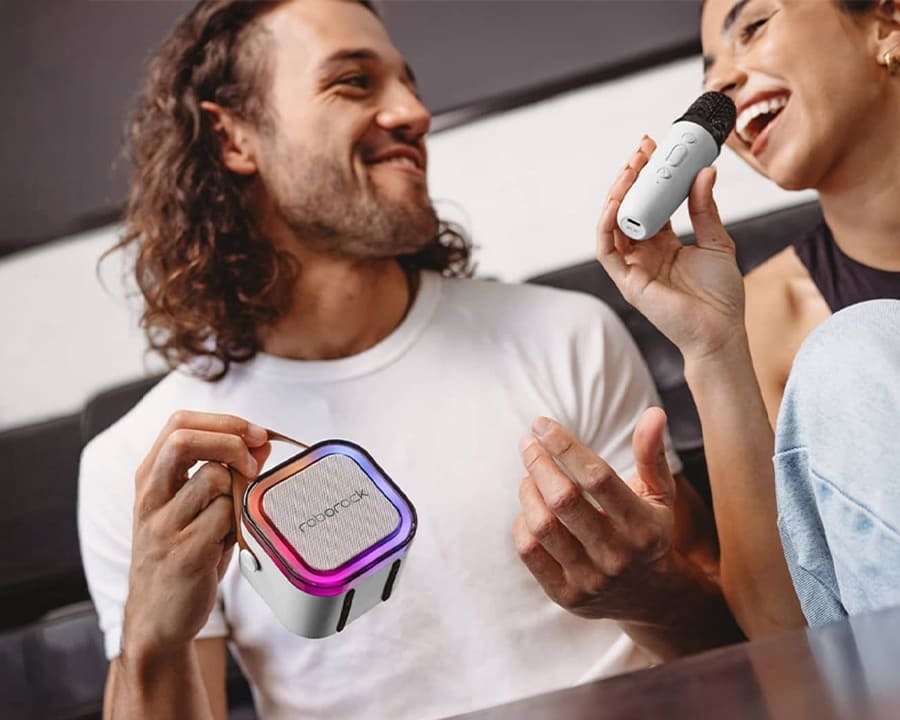 Two people singing with a portable karaoke machine