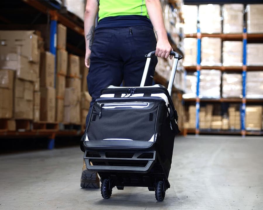 Person carrying an Arctic Zone titan deep freeze rolling cooler bag