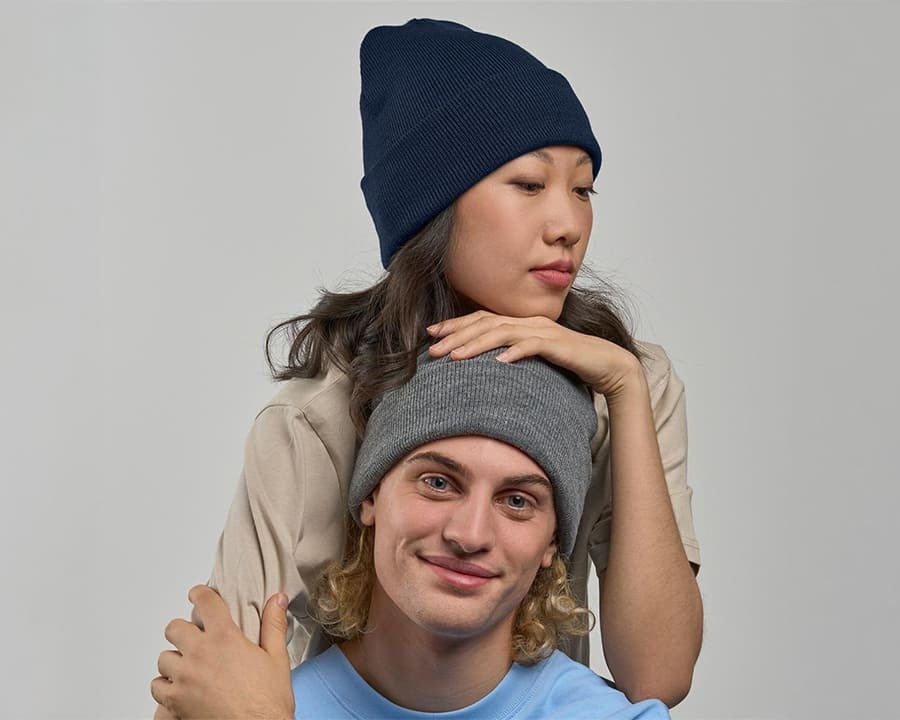 Man and woman both wearing Atlantis eko beanies