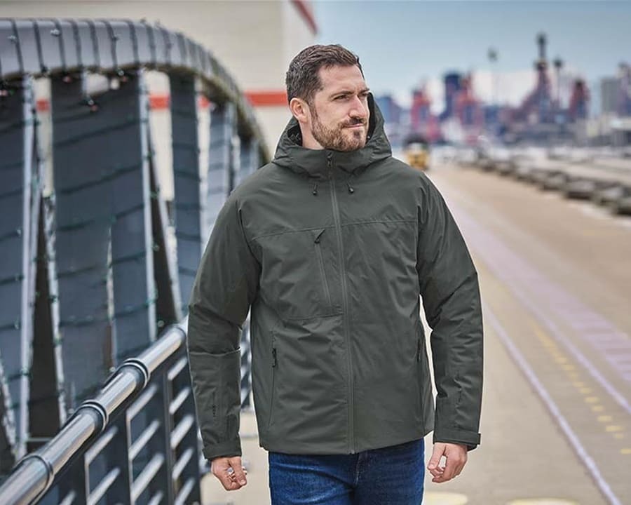 A man wearing a grey thermal nostromo thermal shell jacket