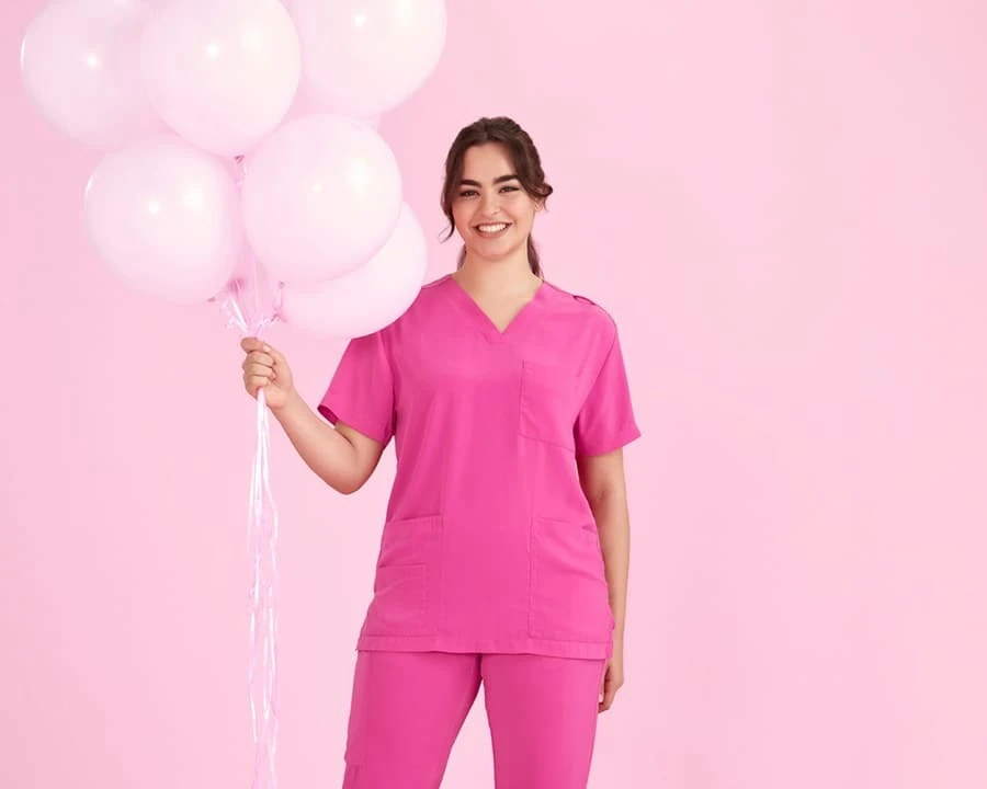 A female nurse wearing BizCollection pink scrubs